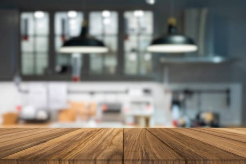 wooden tabletop over defocused kitchen background - food stock pictures, royalty-free photos & images