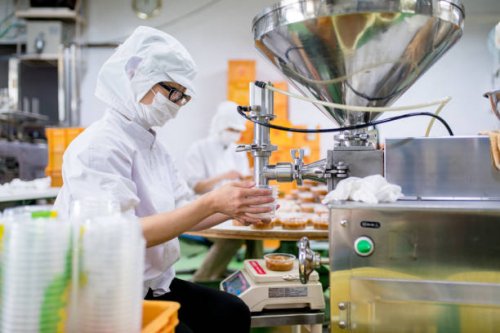 workers in a food processing factory packaging food - food stock pictures, royalty-free photos & images