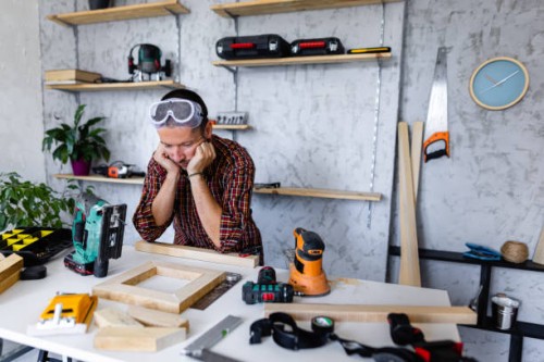 worried carpenter looking his product - home decoration stock pictures, royalty-free photos & images