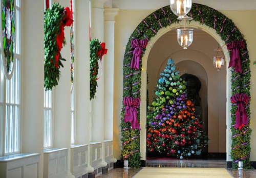 Wreaths of pine and stained glass cover windows in a long hallway leading to the East Garden room as the First Lady welcomes military families to...