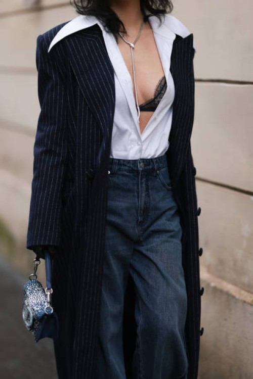 Xiayan Guo seen wearing denim dark blue jeans, Valentino jeans shimmery bag, striped navy long coat, white blouse, black laced bra and black...