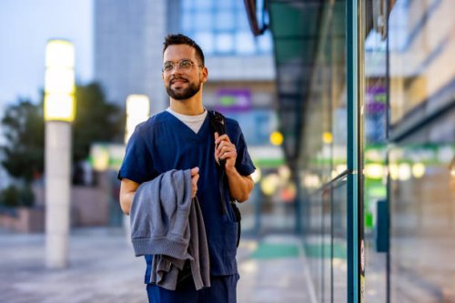 young adult male nurse traveling through the city - travel stock pictures, royalty-free photos & images
