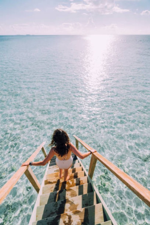 young adult woman chasing the sun in maldives - fashion stock pictures, royalty-free photos & images