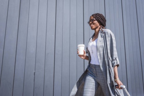 young, african-american businesswoman walking from the airport - fashion stock pictures, royalty-free photos & images