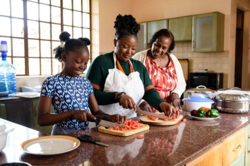young african girl cooking with mother and grandmother - food stock pictures, royalty-free photos & images