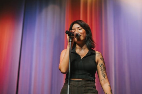 young asian chinese solo female singer singing performance on stage - concert stock pictures, royalty-free photos & images