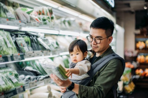 young asian father with cute little daughter grocery shopping for fresh organic vegetables in supermarket - food stock pictures, royalty-free photos & images