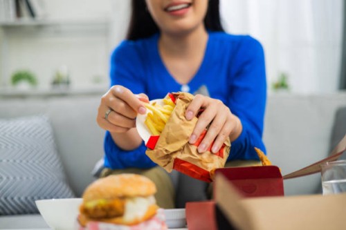 young asian woman happy about the fast delivery of food - junk food stock pictures, royalty-free photos & images