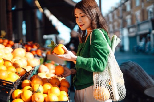 young asian woman shopping fresh fruits and vegetables at organic food market - food stock pictures, royalty-free photos & images