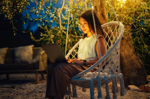 young asian woman using laptop in the garden at night - garden decoration stock pictures, royalty-free photos & images