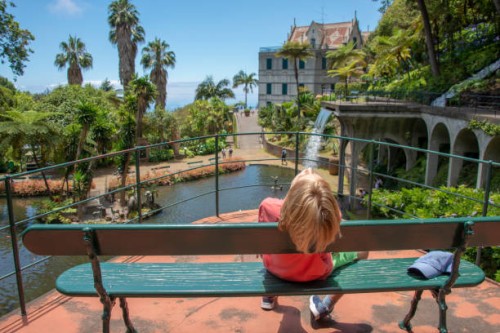 young boy relaxing on the beanch, fountain in the monte palace garden located in funchal, madeira island, portugal - garden decoration stock pictures, royalty-free photos & images