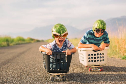 young boys racing wearing watermelon helmets - food stock pictures, royalty-free photos & images