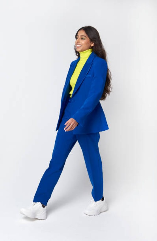 young business woman walking with a cheerful expression - fashion stock pictures, royalty-free photos & images
