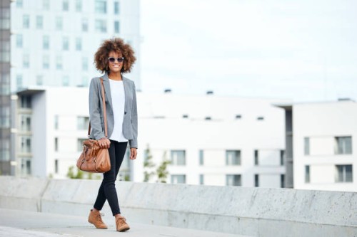 young businesswoman walking in city - fashion stock pictures, royalty-free photos & images