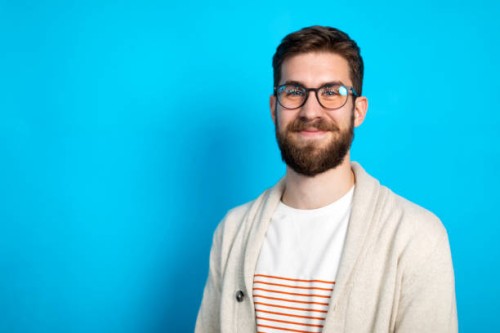 young caucasian man posing against blue background - fashion stock pictures, royalty-free photos & images