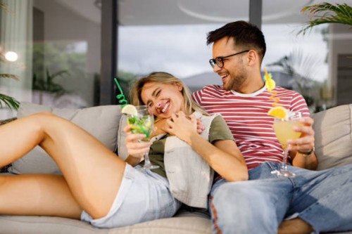 young cheerful couple enjoying together on a patio. - home decoration stock pictures, royalty-free photos & images