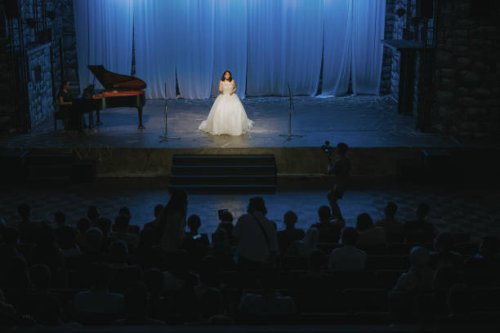 young chinese female opera singer performing solo on stage with pianist - concert stock pictures, royalty-free photos & images