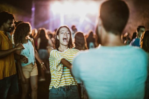 young couple dancing and singing on music concert by night. - concert stock pictures, royalty-free photos & images