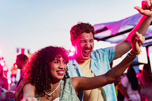 young couple dancing on party outdoors - concert stockfoto's en -beelden