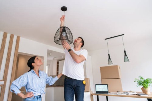 young couple decorating their new home in a modern style - home decoration stock pictures, royalty-free photos & images