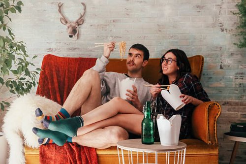 young couple eating chinese take-away food at home - junk food stock pictures, royalty-free photos & images