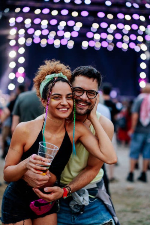 young couple enjoying favorite band at music festival. - concert stock pictures, royalty-free photos & images