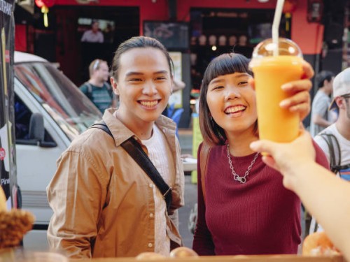 young couple enjoying food truck life in khao san road. bangkok, - junk food stock pictures, royalty-free photos & images
