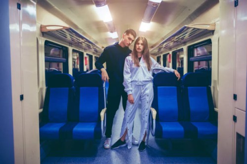 young couple in a train vehicle - fashion stock pictures, royalty-free photos & images