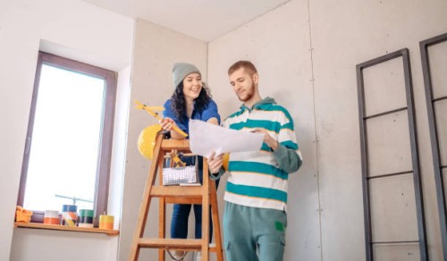 young couple in new home - home decoration stock pictures, royalty-free photos & images