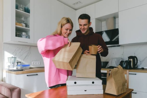 young couple man and woman ordered pizza delivery and asian food home - junk food stock pictures, royalty-free photos & images