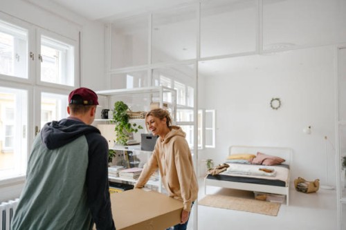 young couple moving into a new apartment - home decoration stock pictures, royalty-free photos & images