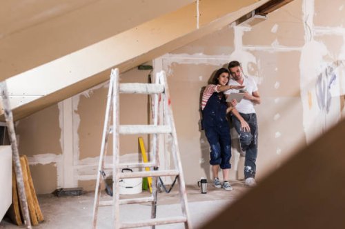 young couple on construction site of their new home, using digital tablet - home decoration stock pictures, royalty-free photos & images