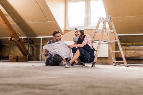 young couple on construction site of theit new home - home decoration stock pictures, royalty-free photos & images