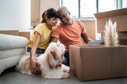 young couple packing and moving boxes at home - home decoration stock pictures, royalty-free photos & images