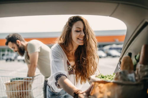 young couple packing groceries - food stock pictures, royalty-free photos & images