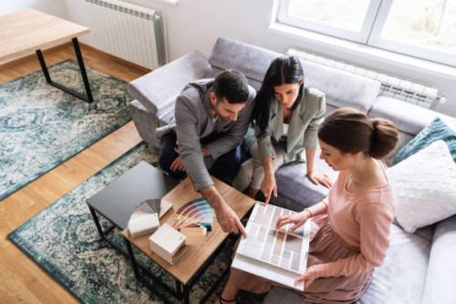 young couple pointing together at the color that they like - home decoration stock pictures, royalty-free photos & images