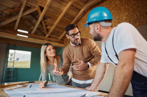 young couple talking about housing design with manual worker. - home decoration stock pictures, royalty-free photos & images