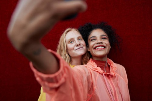 young female friends photographing outdoors - fashion stock pictures, royalty-free photos & images