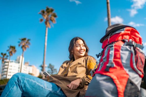 young female traveller using smart phone while enjoying her vacation - travel stock pictures, royalty-free photos & images