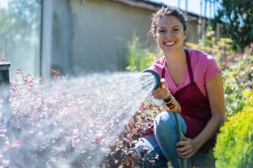 young florist working in the garden - garden decoration stock pictures, royalty-free photos & images