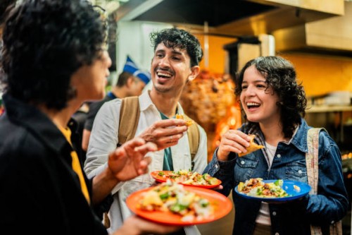 young friends talking and eating taco outdoors - food stock pictures, royalty-free photos & images