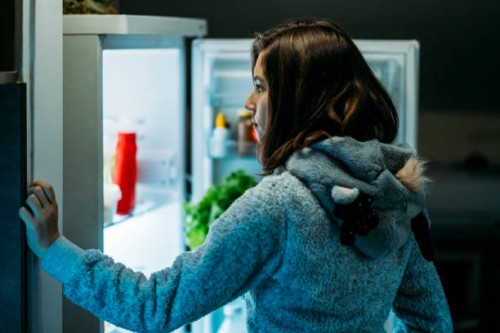 young girl at night in front of a refrigerator - junk food stock pictures, royalty-free photos & images