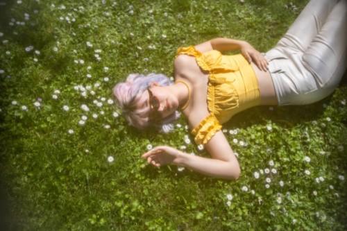 young girl with colored hair lies on the daisy blooming grass - fashion stock pictures, royalty-free photos & images