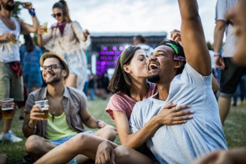 young happy couple having fun with friends on a music festival. - concert stock pictures, royalty-free photos & images