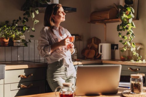 young happy woman drinking coffee on the kitchen in the morning. - coffee stock pictures, royalty-free photos & images