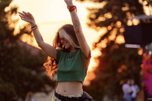 young happy woman having fun while dancing on a music festival at sunset. - concert stock pictures, royalty-free photos & images