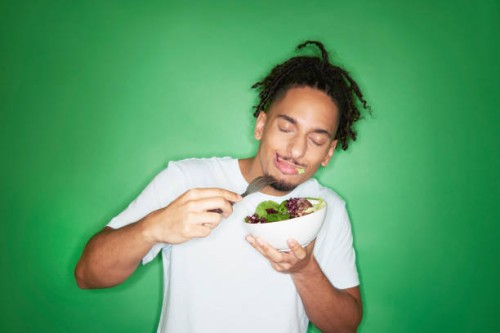 young hipster man eating salad - food stock pictures, royalty-free photos & images