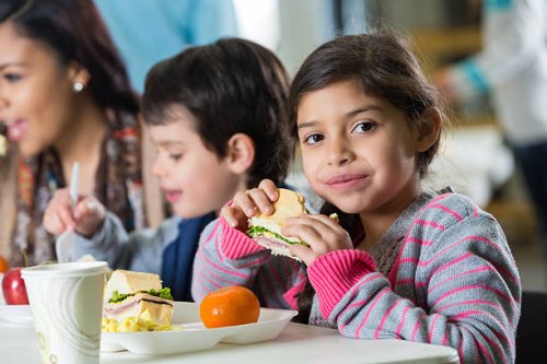 young hispanic family eating meal at neighborhood soup kitchen - food stock pictures, royalty-free photos & images