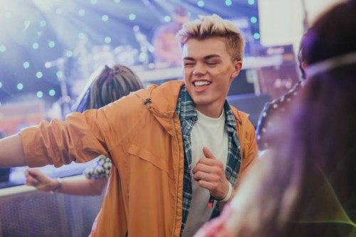 young man dancing at a music festival - concert stock pictures, royalty-free photos & images