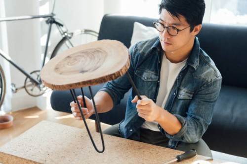young man doing diy, making a stool at home - home decoration stock pictures, royalty-free photos & images